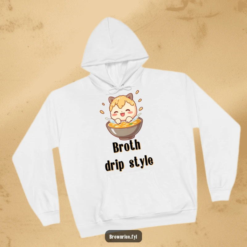 Funny brown rice character splashing in broth, depicted on a cozy and humorous hoodie design.