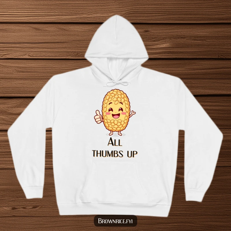 Funny jolly brown rice grain character giving a confident thumbs-up, spreading cheer on a cozy hoodie.
