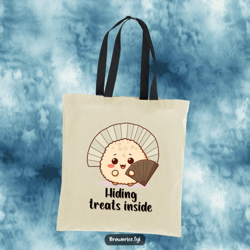 Funny mischievous brown rice ball peeking out from behind a fan, a durable tote bag with a cute and playful cartoon illustration.